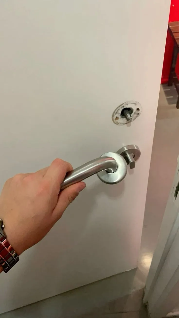 Locksmith technician performing home lockout services and unlocking a residential front door in Tuscaloosa AL