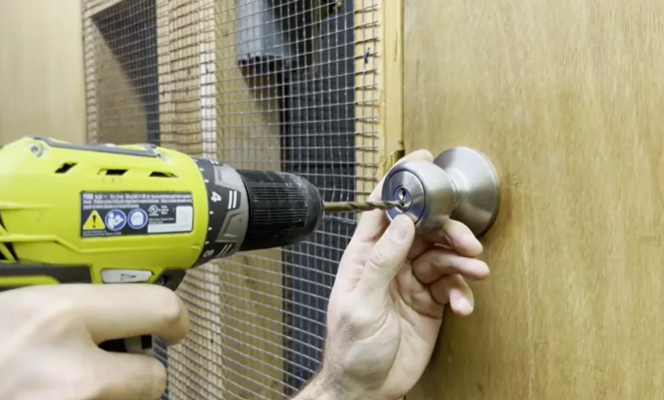 Emergency locksmith technician servicing a lock in Tuscaloosa, AL