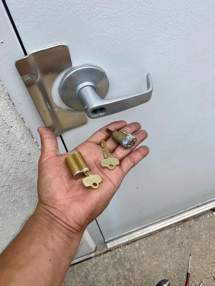 Residential locksmith rekeying a home deadbolt lock in Tuscaloosa, AL